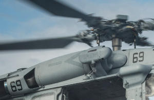 Photo: On this Seahawk helicopter, you can see one of the twin engines tucked beside the rotor mast. The long cylindrical unit is a turboshaft jet engine. A second matching engine sits on the other side, giving redundancy and extra power. If one fails, the other can often keep the aircraft controllable long enough to land safely.